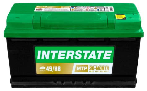 Car battery with Interstate label, green top whilte case. Rescessed terminals with covers.