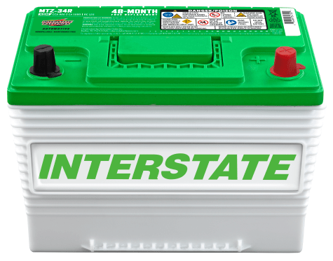 An Interstate Automotive Battery with a green and white casing and red terminals on top.