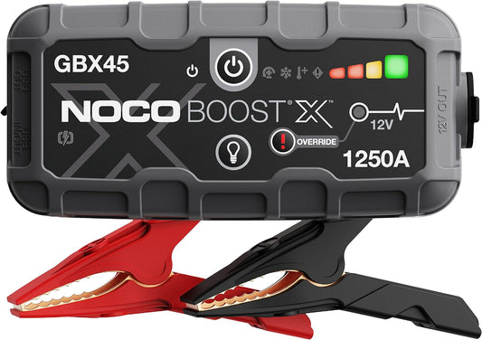 A portable lithium jump starter with a gray and black casing, branded NOCO Boost X, with a red and black design shown in front.